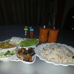 A picture of Rice and beans with groundnut oil and Salad.