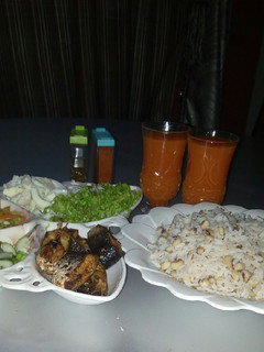 A picture of Rice and beans with groundnut oil and Salad.