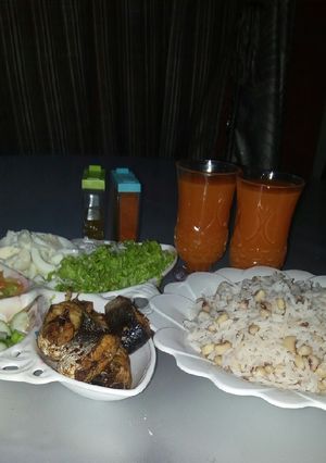 A picture of Rice and beans with groundnut oil and Salad.