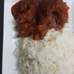 A picture of Stew and rice.