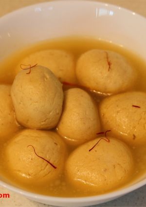 A picture of Kesar Rasgulla / Saffron Cottage Cheese Balls In Sugar Syrup.