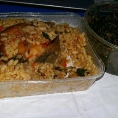 A picture of Ofada Rice Jollof with Vegetable Sauce.