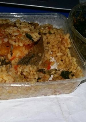 A picture of Ofada Rice Jollof with Vegetable Sauce.
