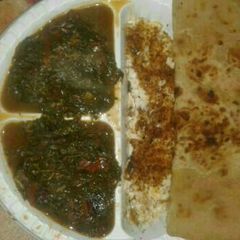 A picture of Terere stew, eggs and chapati.