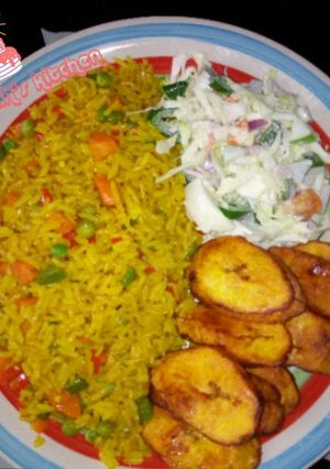 A picture of Fried rice with coleslaw and plantain.