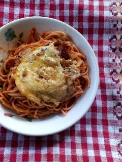 A picture of Jollof Spaghetti and Omelette.