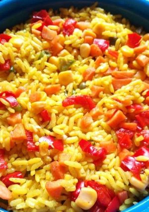 A picture of Garnished palmoil rice.