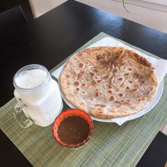 A picture of Aloo ka paratha with lassii.