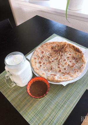 A picture of Aloo ka paratha with lassii.