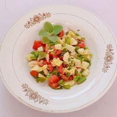 A picture of Ajwain leaf salad with veggies and pineapple.