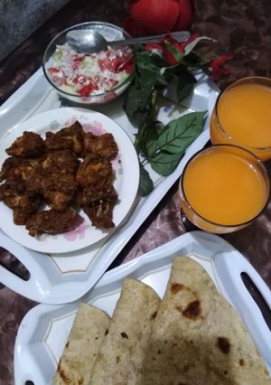 A picture of Koila dum karahi and roti with salad or tang.