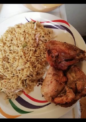 A picture of Fried rice with grilled chicken.