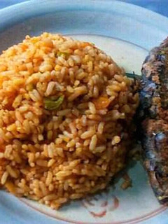 A picture of Carrot and Green Pepper Jollof Rice with Fried Fish.