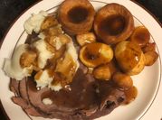 A picture of roast beef and potatoes