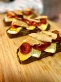 Warm Toasts with Brie, Roasted Cherry Tomatoes, and Melva