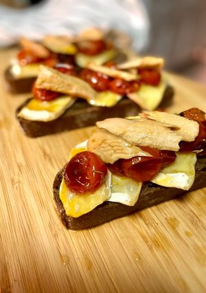 A picture of Warm Toasts with Brie, Roasted Cherry Tomatoes, and Melva.