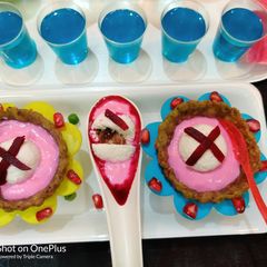 A picture of Pan Stuffed Sandesh floating on Shrikhand in Mutter Basket.