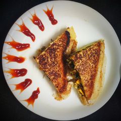 A picture of Leftover Methi Corn stuffed Rava Sandwich.