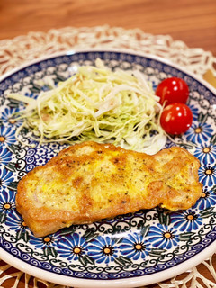 A picture of Curry flavored pork piccata with parmesan.