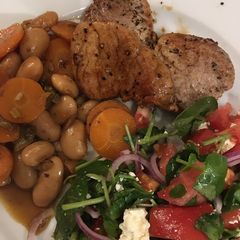 A picture of Pork medallions with lemony butter beans.