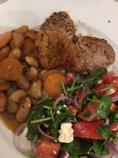 A picture of Pork medallions with lemony butter beans.