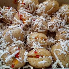 A picture of Baked potatoes with stuffings and grated feta cheese.
