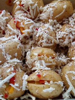 A picture of Baked potatoes with stuffings and grated feta cheese.