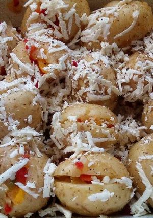 A picture of Baked potatoes with stuffings and grated feta cheese.