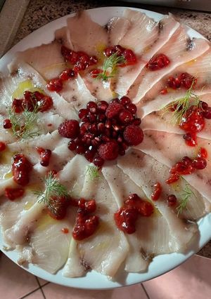 A picture of Swordfish Carpaccio with Berries.