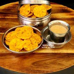 Rice Flour Moong dal + Chanadal Crispy Crackers - Thattai With Kapi - South Indian Gluten-Free Snack A picture of Rice Flour Moong dal + Chanadal Crispy Crackers - Thattai With Kapi - South Indian Gluten-Free Snack.