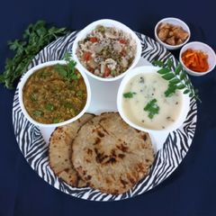 Gujarati thali: Jowar rotla with baigan bharta, pulav and kadhi A picture of Gujarati thali: Jowar rotla with baigan bharta, pulav and kadhi.