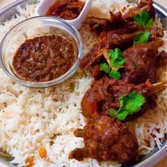 A picture of Peri peri goat with rice.