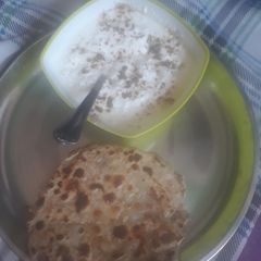 A picture of Aalu parantha with curd.
