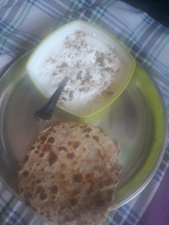 A picture of Aalu parantha with curd.