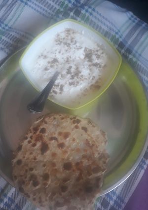 A picture of Aalu parantha with curd.