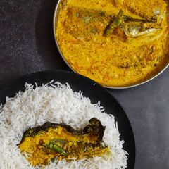 A picture of Pabda Paturi (with Taro/ kochu/Alvi leaves) and Pabda Bhappa.
