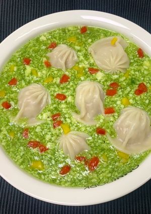 A picture of Jade Egg Drop Soup with Soup Dumplings.