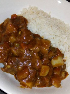 A picture of Rice and vegetable beef stew.
