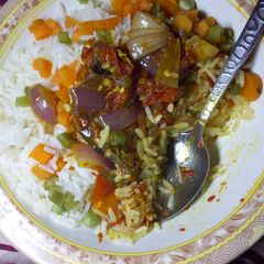 A picture of Garnished White Rice with Onion Sauce.