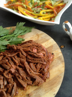 A picture of Jamaican pulled beef with brown sauce and pickled veg.