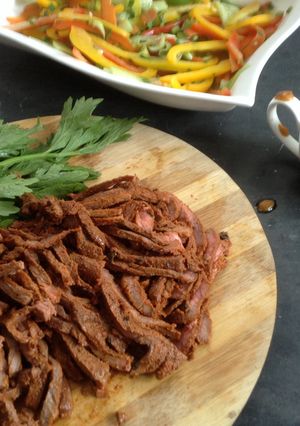 A picture of Jamaican pulled beef with brown sauce and pickled veg.