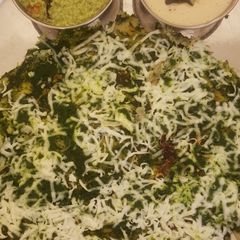 A picture of Spinach cheese dosa with peanut chutney.
