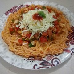 A picture of Cheesy Schezwan noodles with stirfry vegetables.