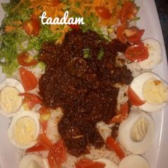 A picture of Rice and stew with veggies.