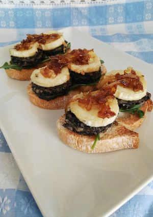A picture of Goat Cheese and Blood Sausage Toasts with Caramelized Onion.