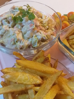 A picture of Russian salad with fries.