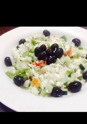 A picture of Feta cheese salad and black olives.