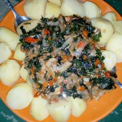 A picture of Boiled Irish potatoes with ugu sauce.