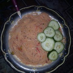 A picture of Simple spaghetti ganished with cucumber.