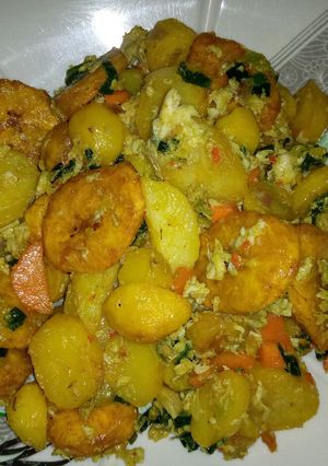 A picture of Fried plantain and potato with egg.